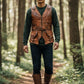 Man wearing a Scarlett Stitch distressed brown leather utility vest with a belt and pockets in a forest setting.