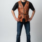 Model wearing a Scarlett Stitch vintage style brown distressed leather utility vest with pockets and waist belt.