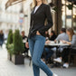 Scarlett Stitch women's black tailored fit blazer jacket with sharp lapels and three-button closure, worn with jeans.