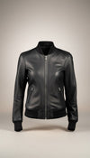 Scarlett Stitch Women's black faux leather bomber jacket with ribbed collar, cuffs, and hem. Features full-zip front and zippered side pockets.