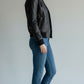 Scarlett Stitch Women's black faux leather bomber jacket with ribbed collar, cuffs, and zippered pockets.
