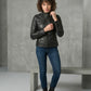 Scarlett Stitch Women's black faux leather moto jacket with zippered pockets and stand-up collar.