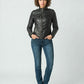 Scarlett Stitch Women's black faux leather moto jacket with zippered pockets and snap-button collar. Model wears jeans and boots.