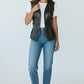 Scarlett Stitch Women's black faux leather motorcycle vest with lapel collar, zipper, and buckle straps. Sleeveless.