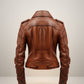 Scarlett Stitch Women's brown leather motorcycle jacket with epaulets and zippered cuffs.
