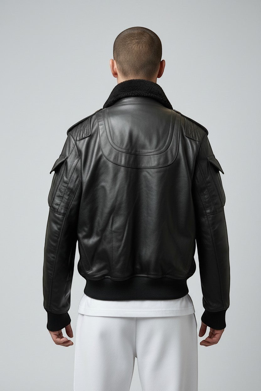 Scarlett Stitch men's black leather bomber jacket with faux fur collar, ribbed cuffs, and multiple pockets.