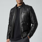 Scarlett Stitch men's black faux leather bomber jacket with stand collar, zippered pockets, and shoulder details.