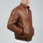 Scarlett Stitch men's brown leather bomber jacket with ribbed collar, cuffs, and hem. Zip-front closure and side pockets.