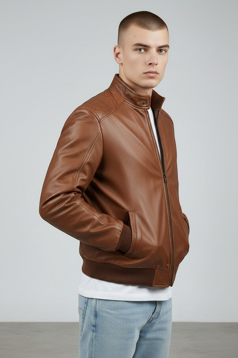 Scarlett Stitch men's brown leather bomber jacket with ribbed collar, cuffs, and hem. Zip-front closure and side pockets.