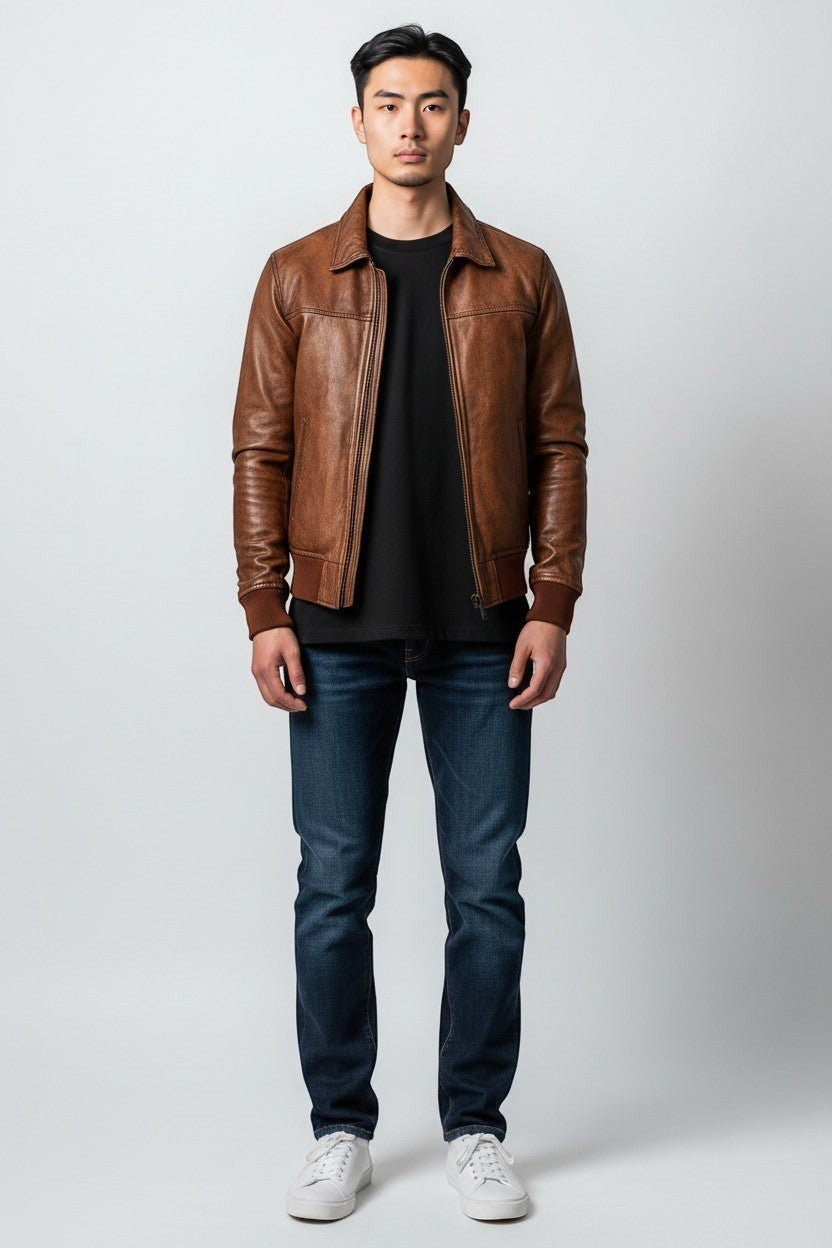 Scarlett Stitch Men's distressed brown genuine leather bomber jacket with ribbed collar, cuffs, and hem.