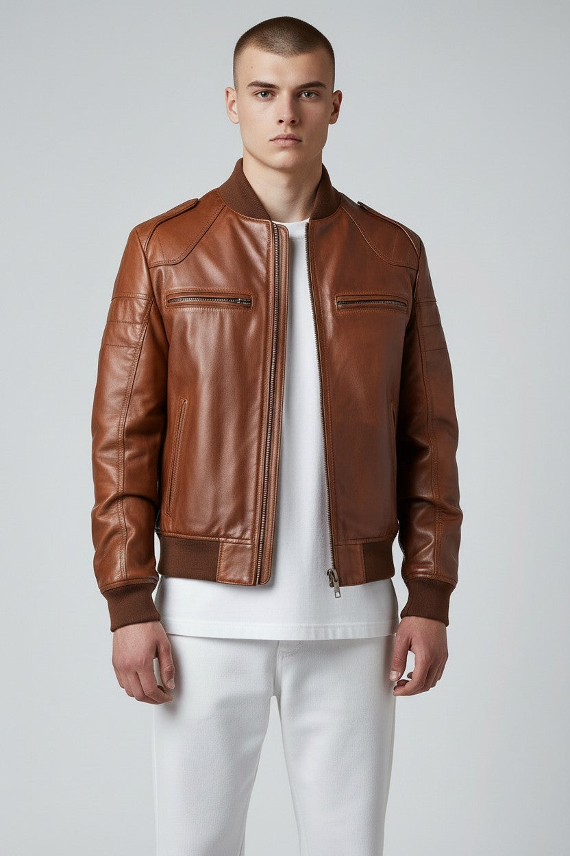 Scarlett Stitch men's brown leather bomber jacket with ribbed collar, cuffs, and hem. Features zippered pockets and a sleek silhouette.
