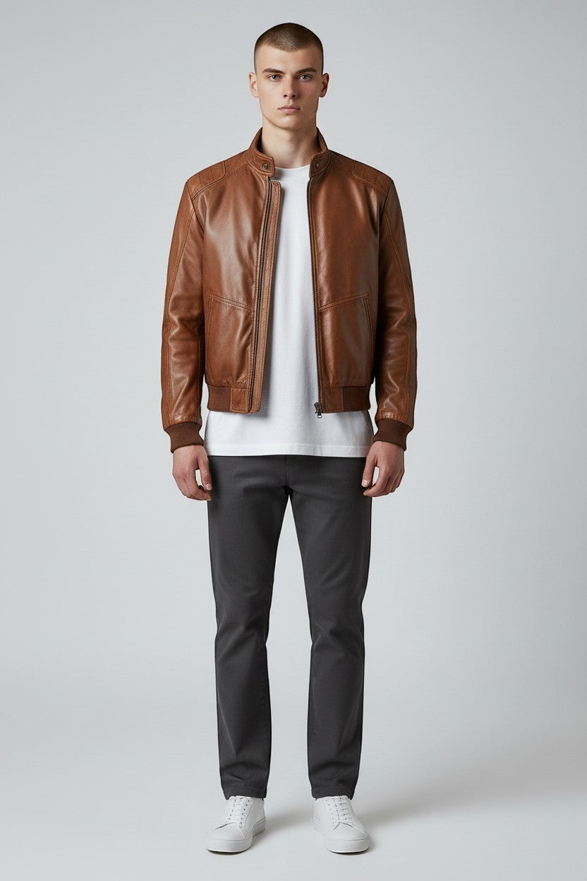 Scarlett Stitch men's brown leather bomber jacket with ribbed collar, cuffs, and hem. Zip-front closure and side pockets.