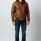 Scarlett Stitch men's distressed brown leather bomber jacket with attached hood, ribbed cuffs and hem, and zip-up front.