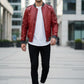 Scarlett Stitch men's red faux leather bomber jacket with ribbed cuffs and sleeve pocket, worn by a model.