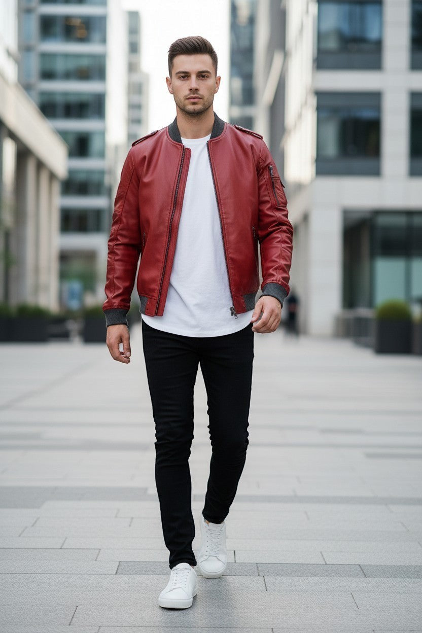 Scarlett Stitch men's red faux leather bomber jacket with ribbed cuffs and sleeve pocket, worn by a model.