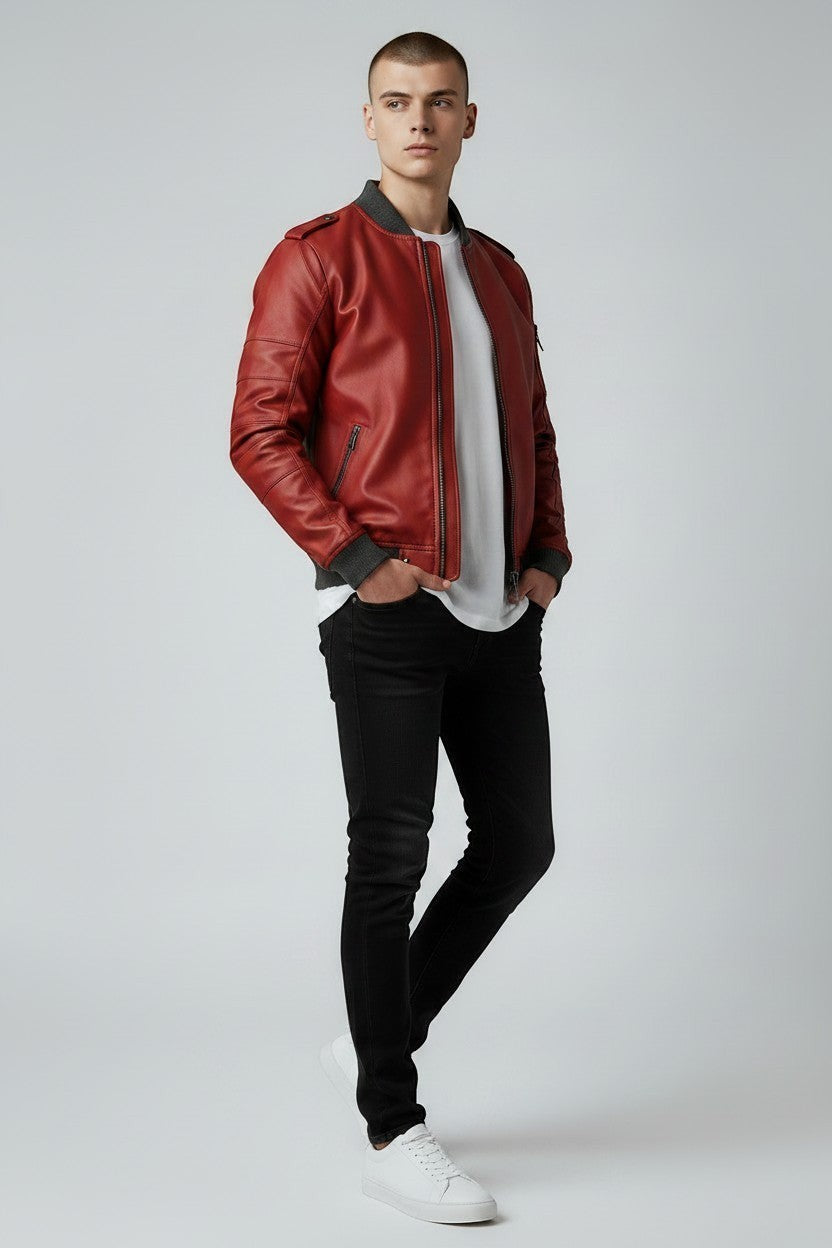 Scarlett Stitch men's red faux leather bomber jacket with ribbed cuffs and sleeve zip pocket. Model wears white tee and black jeans.