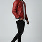 Scarlett Stitch men's red faux leather bomber jacket with ribbed cuffs and grey collar, worn by a model with black jeans and white sneakers.