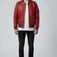 Scarlett Stitch men's red faux leather bomber jacket with ribbed cuffs and grey collar. Model wears white t-shirt and black jeans.