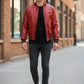 Scarlett Stitch men's red leather bomber jacket with ribbed collar and cuffs, zippered pockets, and satin lining.